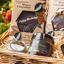 Birthday gift basket containing Teignhouse honey chocolate, Stones honey, lip balm, candle and raw Devon honey