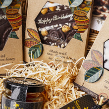 Happy birthday gift basket containing Teignhouse honey chocolate, Stones honey, lip balm, candle  and raw Devon honey