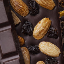 Honey Dark Chocolate made with organic raw cacao and local Devon honey no sugar added, dark, raw, topped with almonds and prunes
